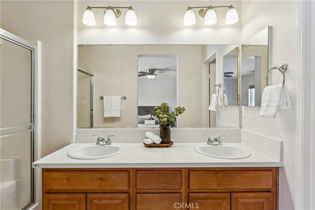 8048 Tulsa Place, Unit 105 Rancho Cucamonga, CA 91730 - Photo 28 of 45 a bathroom with double sink and a mirror