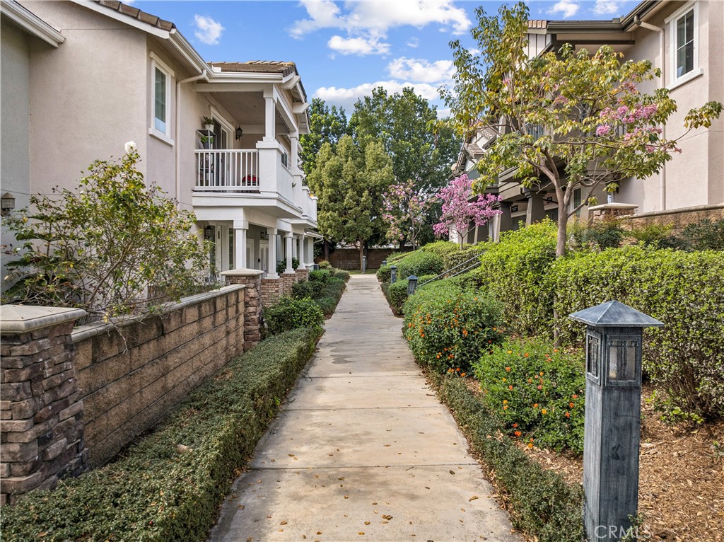 8048 Tulsa Place, Unit 105 Rancho Cucamonga, CA 91730 - Photo 33 of 45 a view of a pathway with house on both side