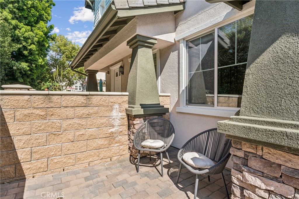 8048 Tulsa Place, Unit 105 Rancho Cucamonga, CA 91730 - Photo 4 of 45 a view of a patio with table and chairs with wooden floor and fence