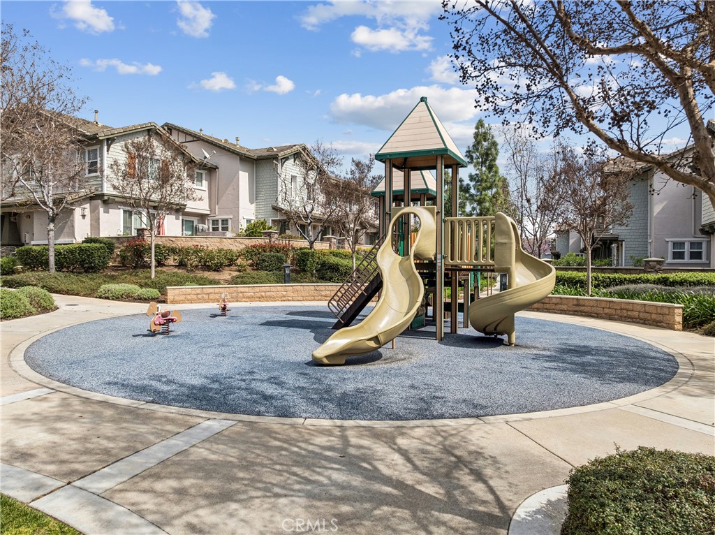 8048 Tulsa Place, Unit 105 Rancho Cucamonga, CA 91730 - Photo 41 of 45 a view of a park with swings and slides