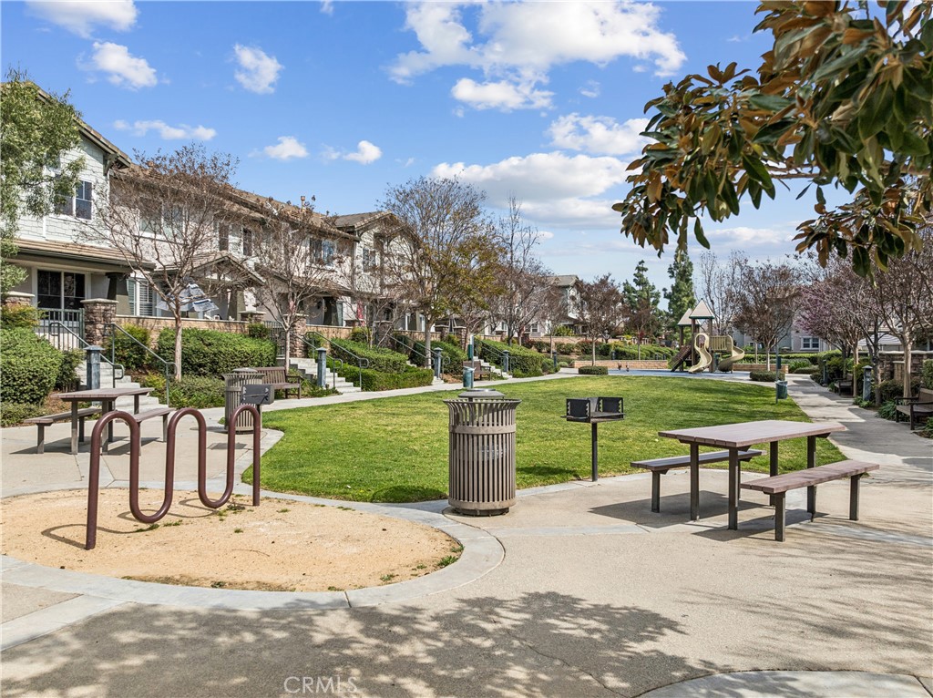 8048 Tulsa Place, Unit 105 Rancho Cucamonga, CA 91730 - Photo 43 of 45 a park view with a bench and garden