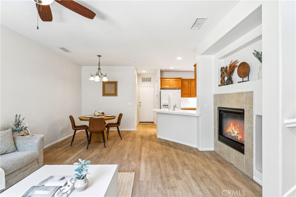 8048 Tulsa Place, Unit 105 Rancho Cucamonga, CA 91730 - Photo 7 of 45 a living room with furniture and a fireplace