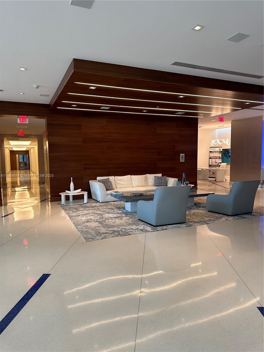 330 Sunny Isles Boulevard, Unit 52002 Sunny Isles Beach, FL 33160 - Photo 11 of 56 a living room with furniture and a fireplace