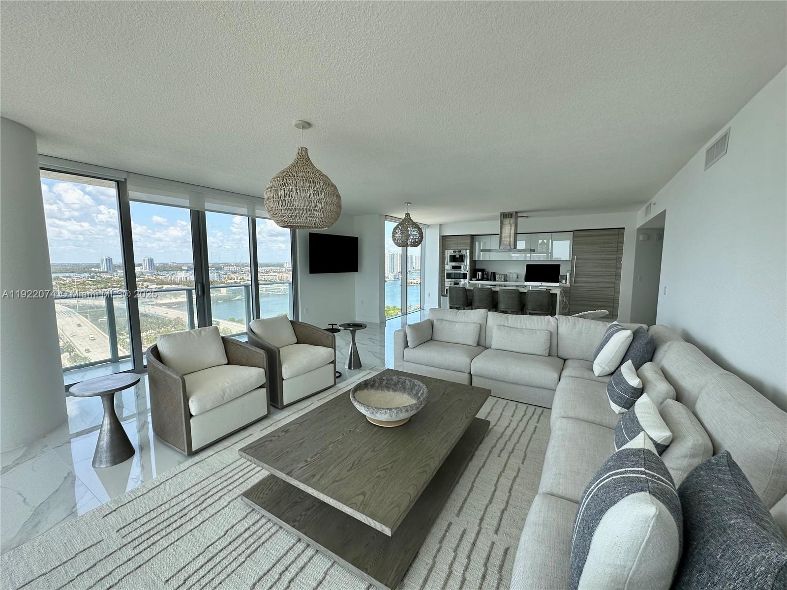 330 Sunny Isles Boulevard, Unit 52002 Sunny Isles Beach, FL 33160 - Photo 23 of 56 a living room with furniture rug and window