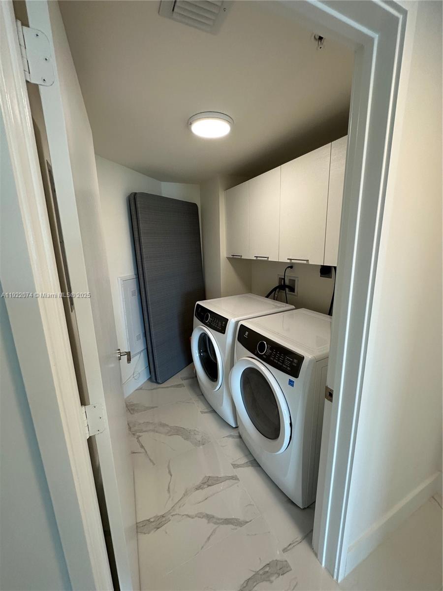 330 Sunny Isles Boulevard, Unit 52002 Sunny Isles Beach, FL 33160 - Photo 42 of 56 a utility room with dryer and washer