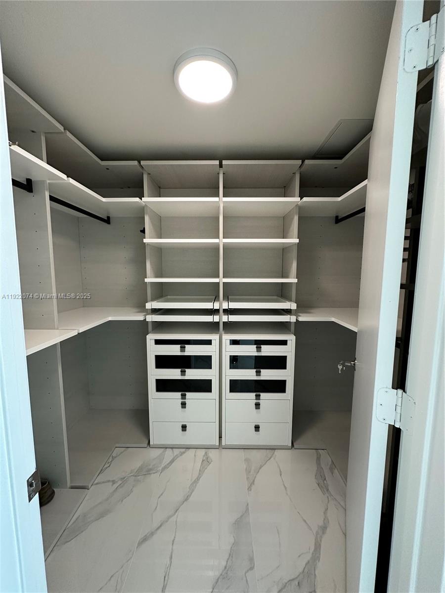 330 Sunny Isles Boulevard, Unit 52002 Sunny Isles Beach, FL 33160 - Photo 49 of 56 a view of walk in closet with empty racks