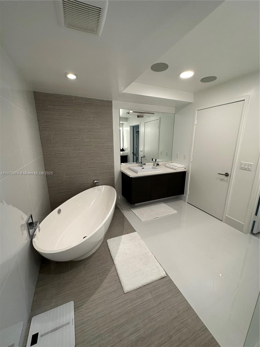 330 Sunny Isles Boulevard, Unit 52002 Sunny Isles Beach, FL 33160 - Photo 51 of 56 a bathroom with a sink a toilet and shower