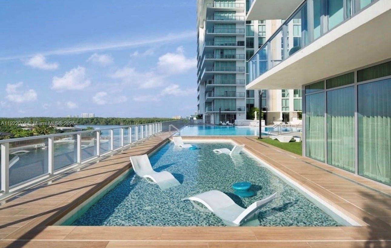 330 Sunny Isles Boulevard, Unit 52002 Sunny Isles Beach, FL 33160 - Photo 7 of 56 a view of a swimming pool with an outdoor seating