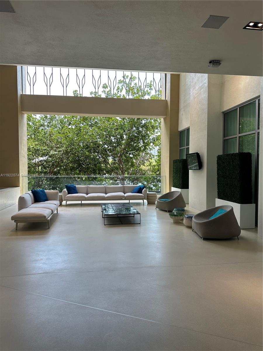 330 Sunny Isles Boulevard, Unit 52002 Sunny Isles Beach, FL 33160 - Photo 8 of 56 a living room with furniture and a large window