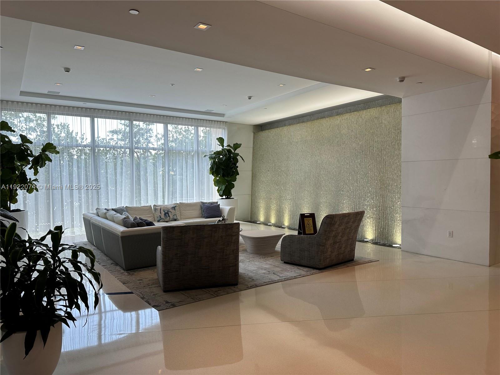 330 Sunny Isles Boulevard, Unit 52002 Sunny Isles Beach, FL 33160 - Photo 9 of 56 a living room with furniture and a potted plant