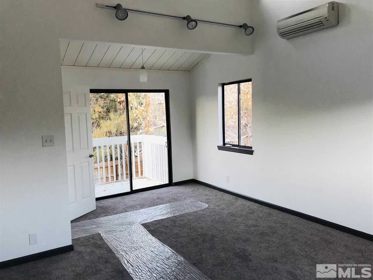 1110 Johnson Place Reno, NV 89509 - Photo 8 of 24 an empty room with wooden floor and windows