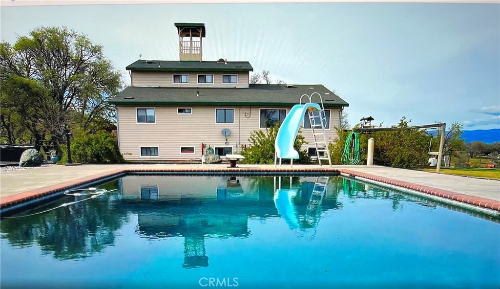 a view of a white house with a swimming pool