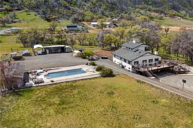 a view of a house with a wooden deck and a yard