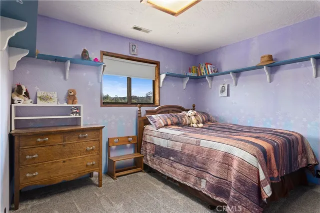 a bedroom with furniture and a chandelier