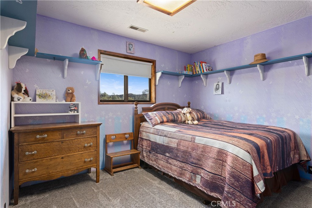 340 Fritch Road Lakeport, CA 95453 - Photo 17 of 65 a bedroom with a bed and a tv on the dresser