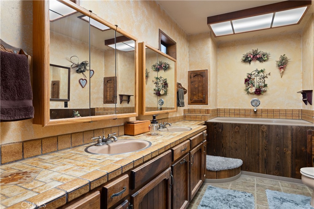340 Fritch Road Lakeport, CA 95453 - Photo 21 of 65 a bathroom with a granite countertop sink a toilet a mirror and shower