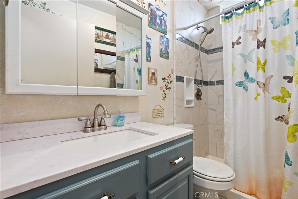 340 Fritch Road Lakeport, CA 95453 - Photo 25 of 65 a bathroom with a sink a toilet and shower curtain