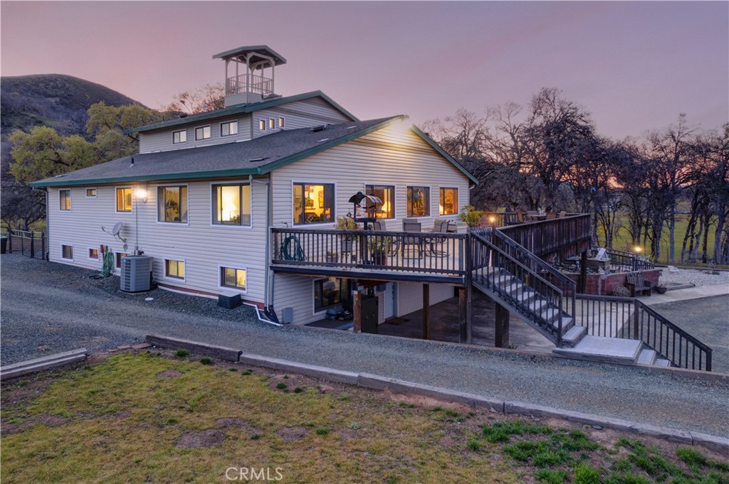 340 Fritch Road Lakeport, CA 95453 - Photo 4 of 65 a view of a house with a wooden deck and a yard