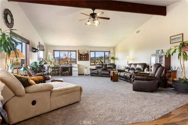 a living room with furniture gym equipment and a large window
