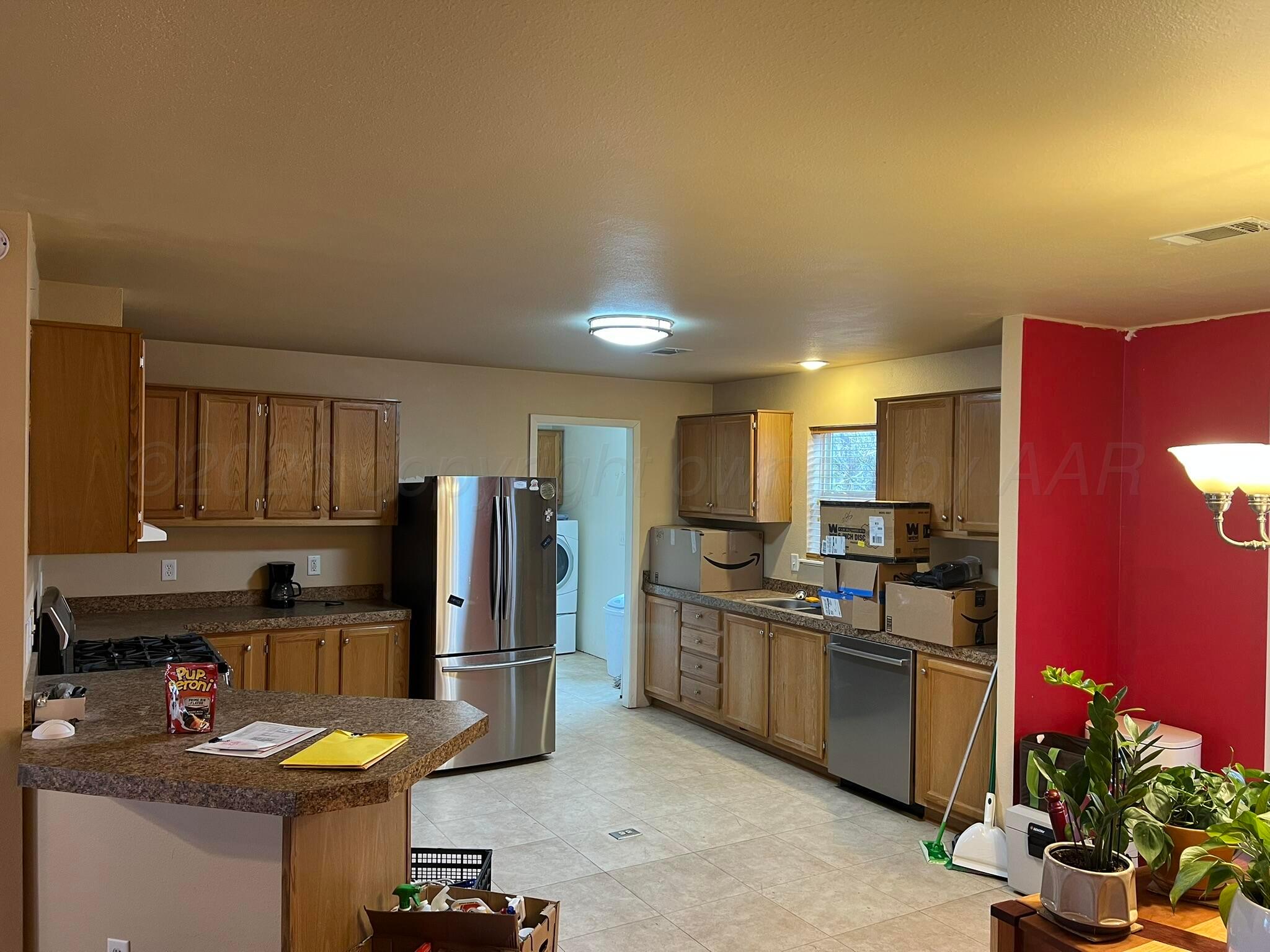 707 Conklin Street Canadian, TX 79014 - Photo 13 of 38 a kitchen with refrigerator and cabinets