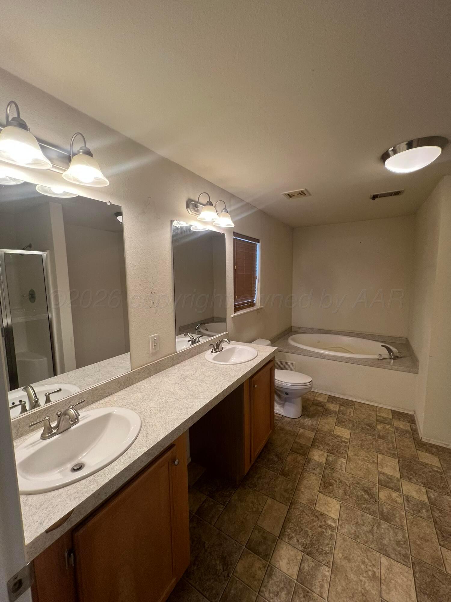 707 Conklin Street Canadian, TX 79014 - Photo 19 of 38 a bathroom with a double vanity sink mirror and toilet