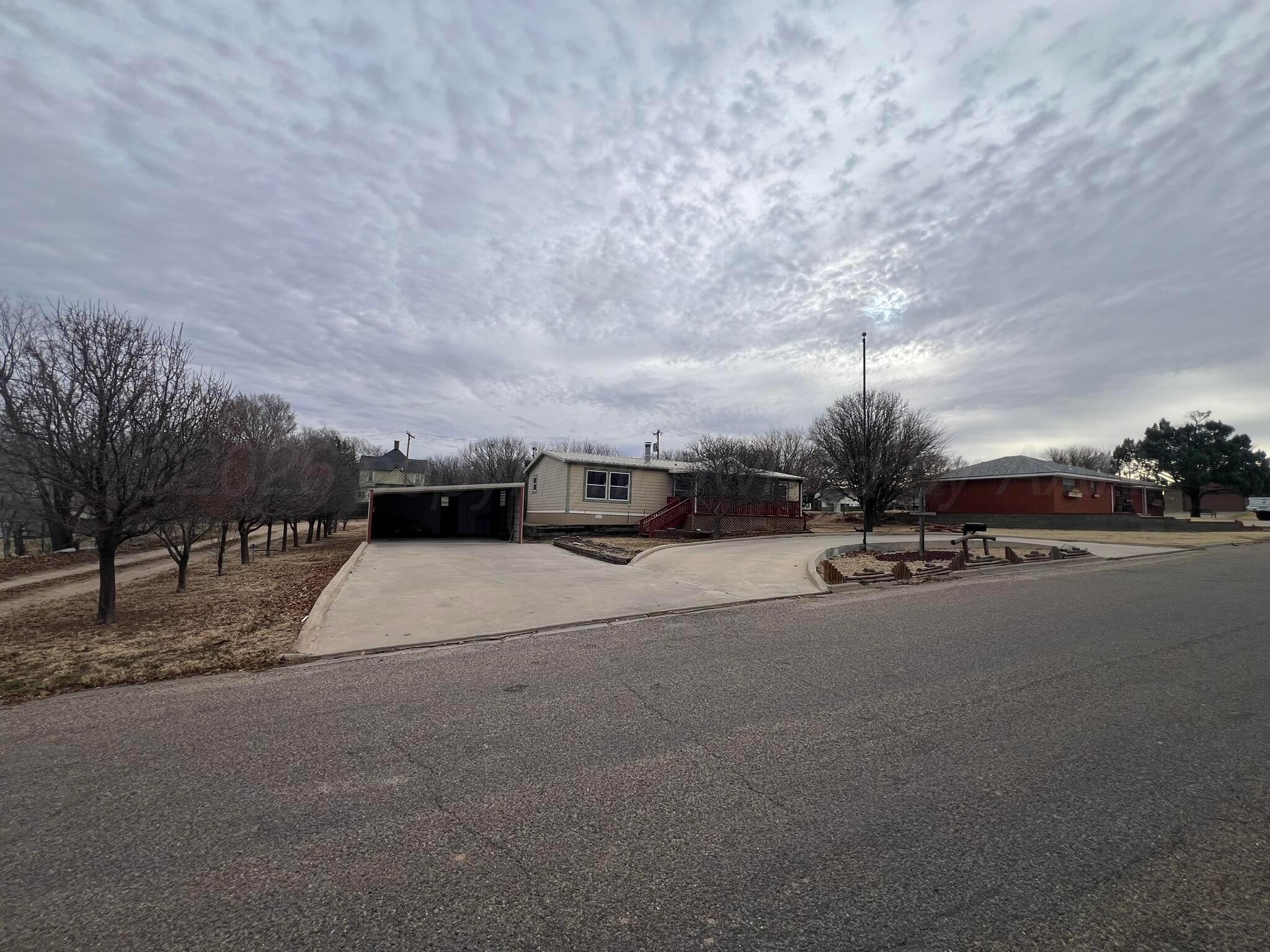 707 Conklin Street Canadian, TX 79014 - Photo 2 of 38 a city street with tall trees