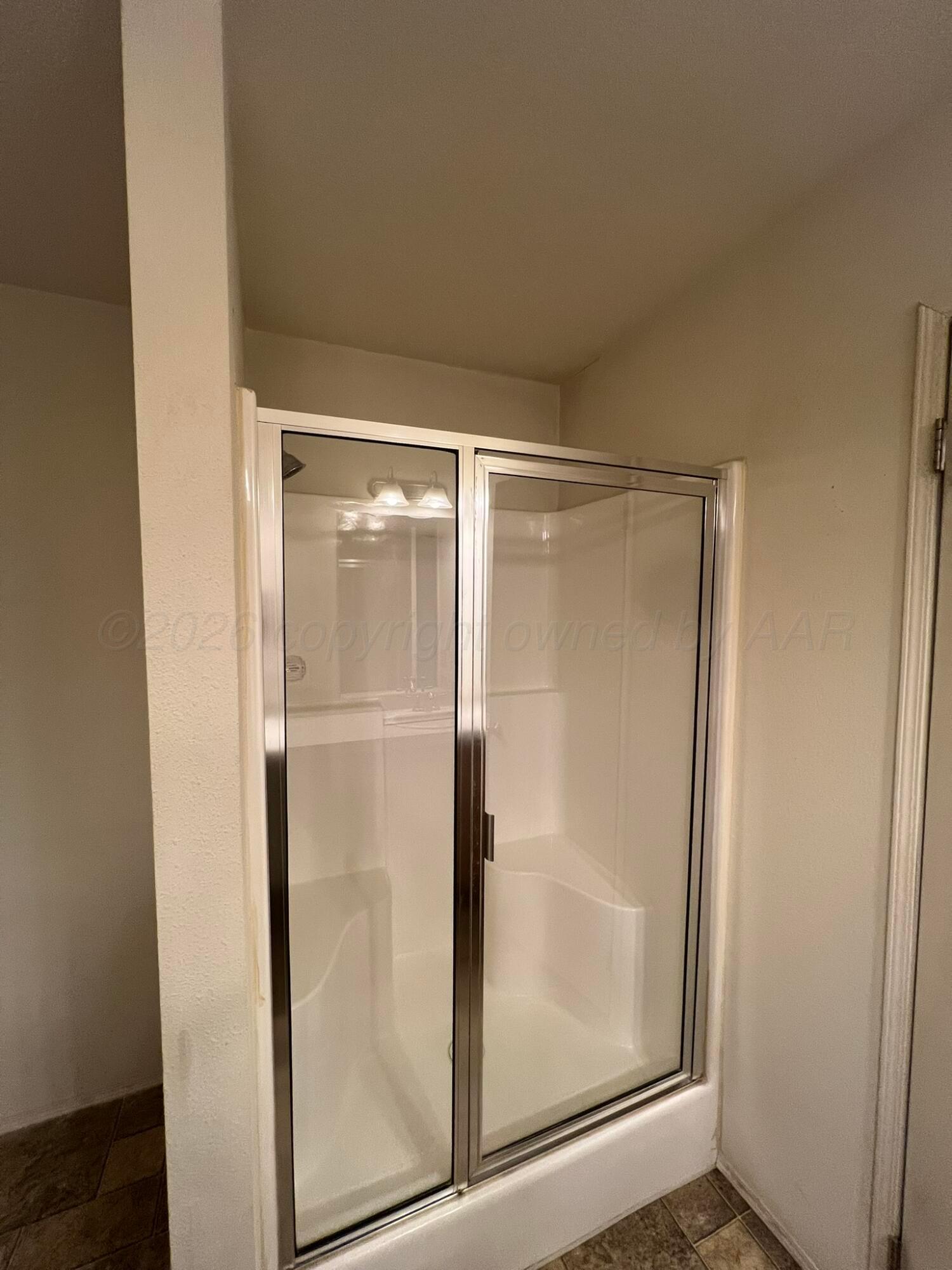 707 Conklin Street Canadian, TX 79014 - Photo 21 of 38 a bathroom with a glass shower door