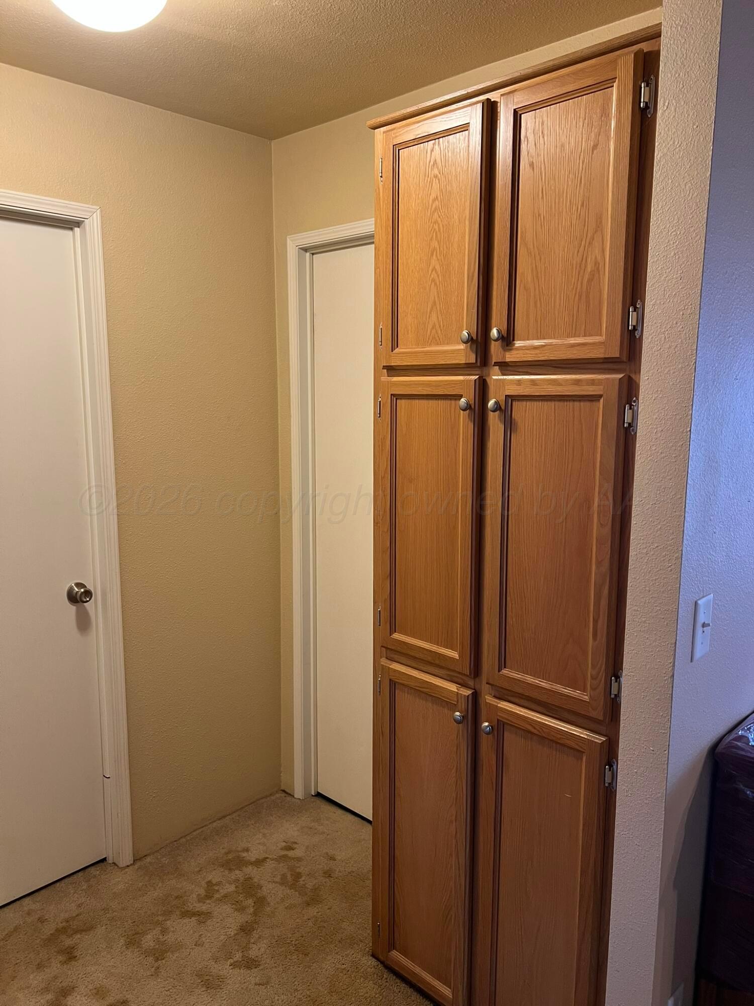 707 Conklin Street Canadian, TX 79014 - Photo 23 of 38 a view of water heater with wooden floor