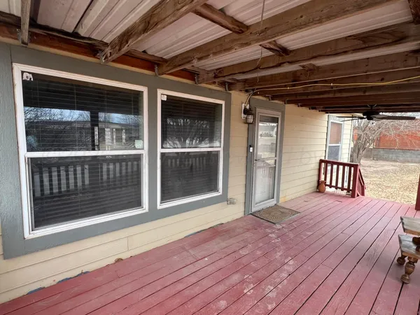a view of a balcony with wooden floor