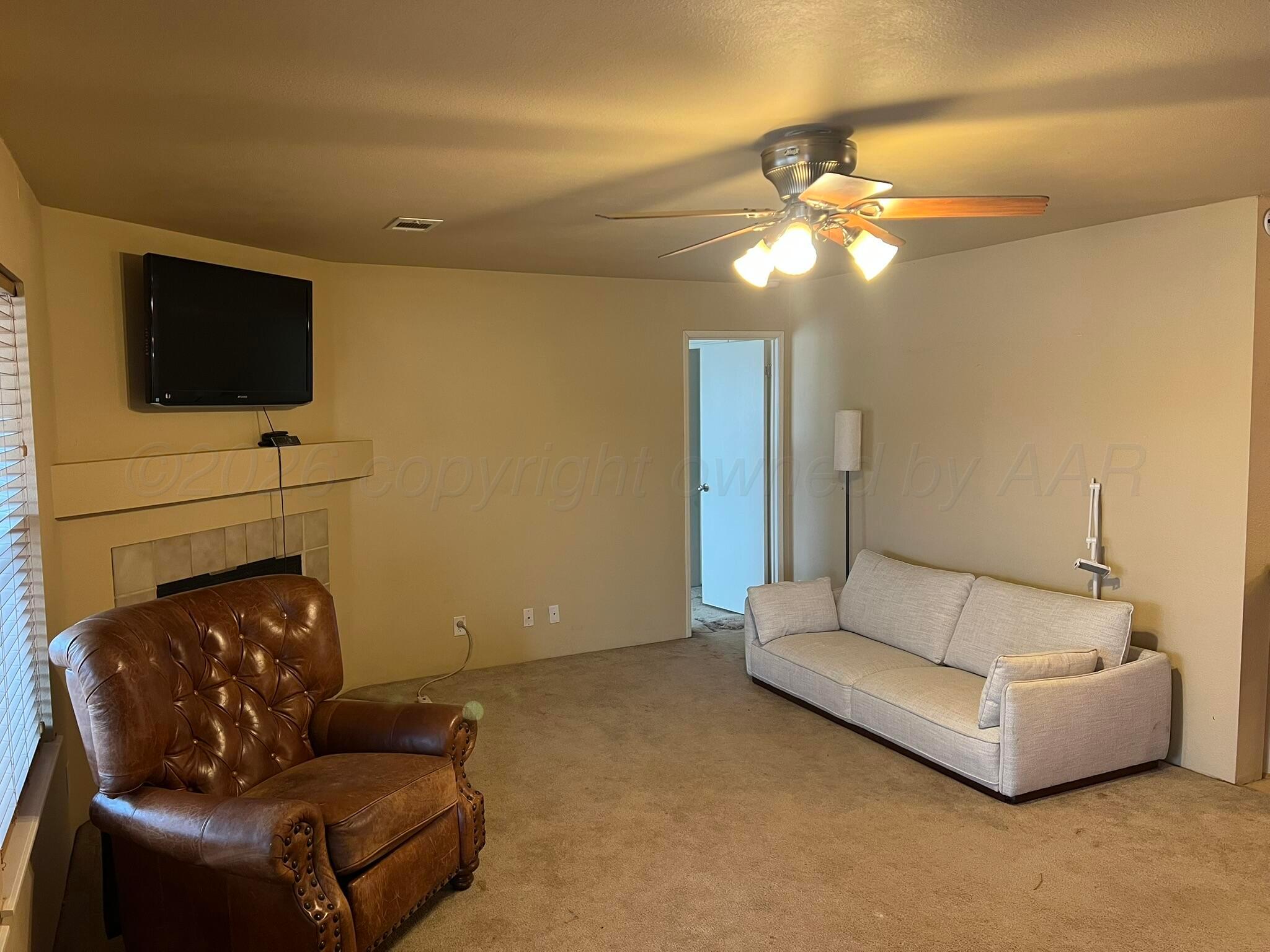 707 Conklin Street Canadian, TX 79014 - Photo 10 of 38 a living room with furniture and a flat screen tv
