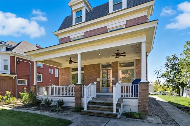 a front view of a house with a garden and plants