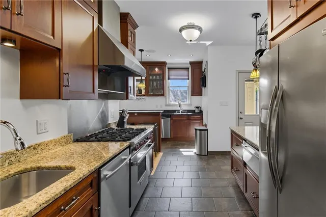 a kitchen with stainless steel appliances granite countertop a stove and a refrigerator