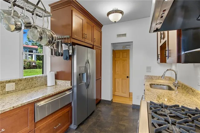 a bedroom with a bed a flat screen tv closet and large window
