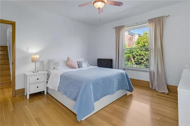 a bedroom with a bed and a window