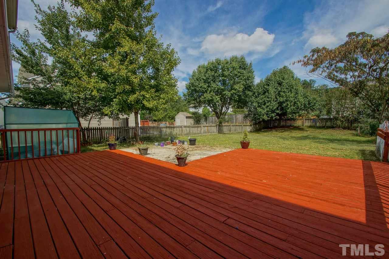 5617 Orchard Gate Way Raleigh, NC 27616 - Photo 22 of 24 Huge deck is the perfect space to enjoy this beautiful yard! Notice the green house!