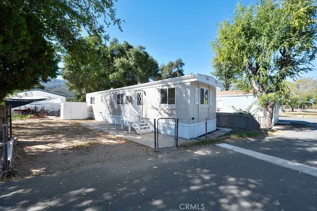 a view of a house with a yard and tree s