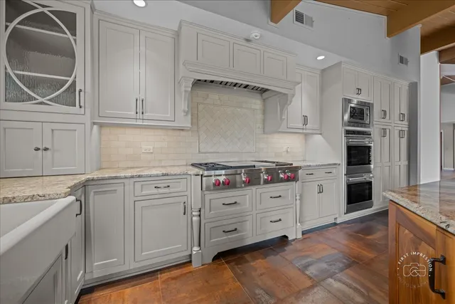 a kitchen with stainless steel appliances granite countertop a stove and a refrigerator