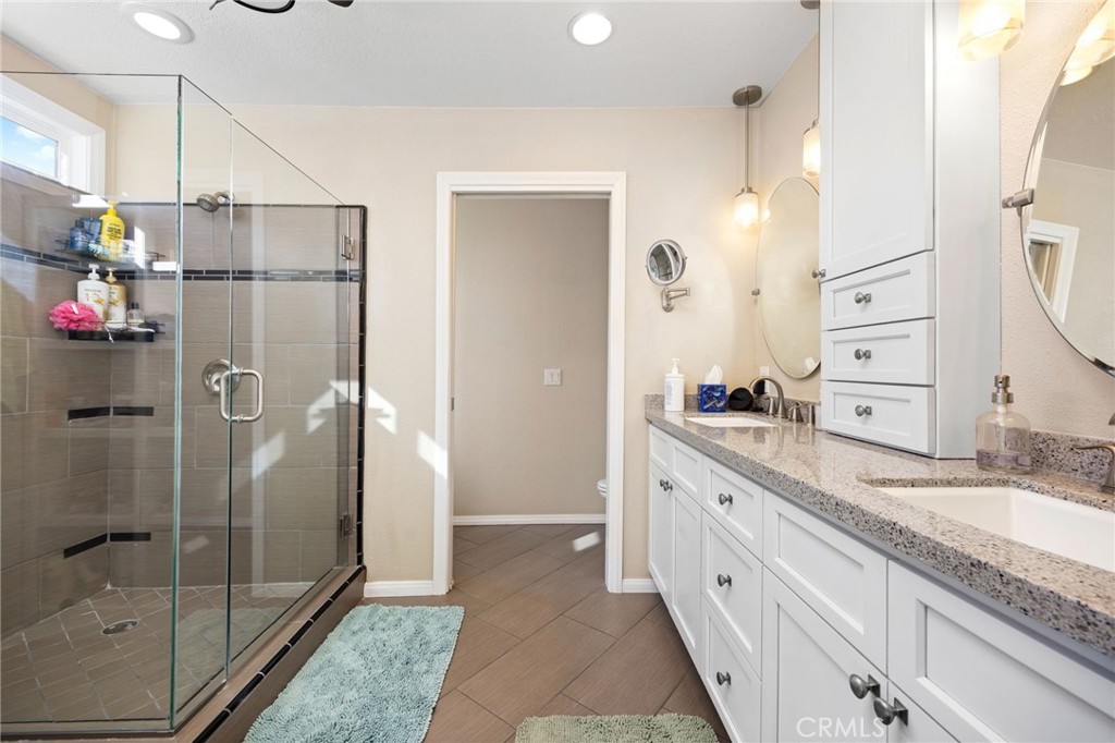 60206 Devils Ladder Road Mountain Center, CA 92561 - Photo 16 of 56 a bathroom with a granite countertop shower sink and mirror