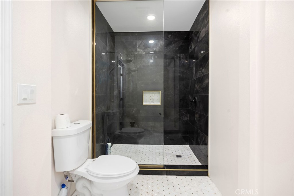 60206 Devils Ladder Road Mountain Center, CA 92561 - Photo 45 of 56 a bathroom with a glass door shower a toilet and a sink