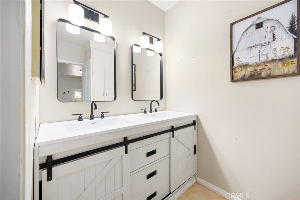 60206 Devils Ladder Road Mountain Center, CA 92561 - Photo 47 of 56 a bathroom with a sink vanity and a mirror