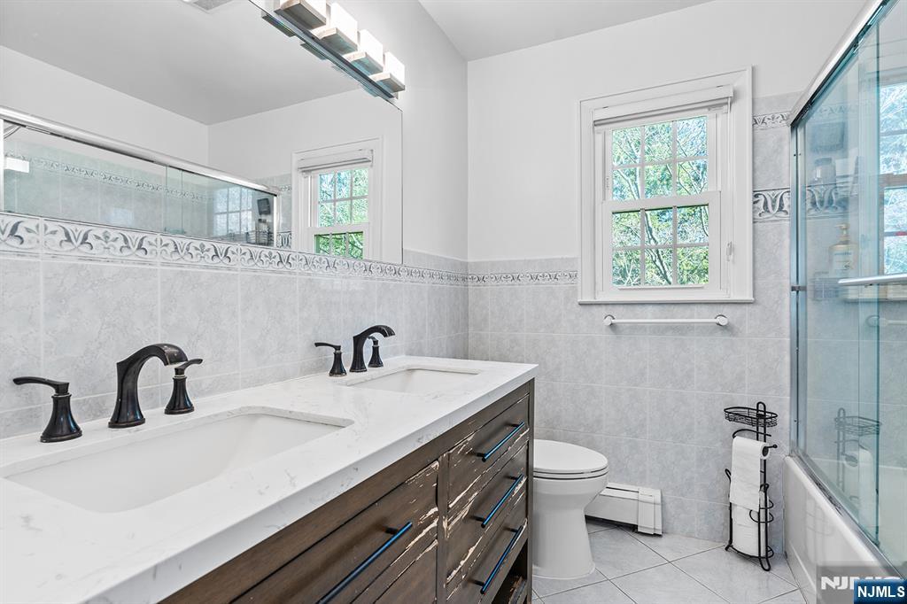 82 Van Horn Street Demarest, NJ 07627 - Photo 13 of 31 a bathroom with a sink a toilet and a mirror