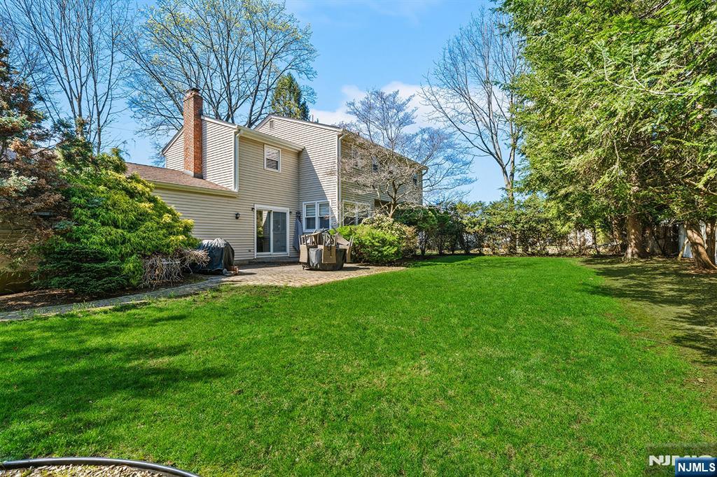 82 Van Horn Street Demarest, NJ 07627 - Photo 24 of 31 a view of a white house next to a yard with big trees
