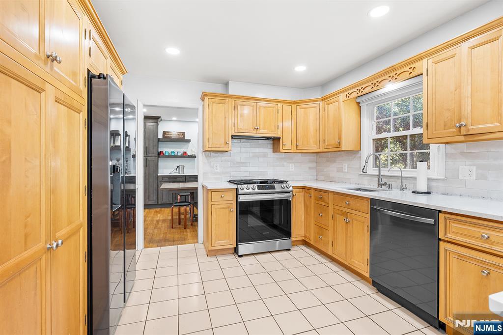 82 Van Horn Street Demarest, NJ 07627 - Photo 9 of 31 a kitchen with stainless steel appliances granite countertop a stove sink and cabinets