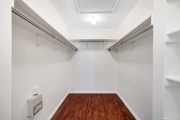 a view of a room with wooden floor