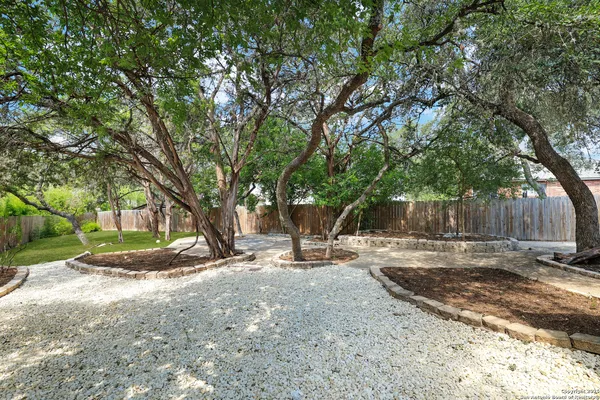 a backyard of a house with trees and houses