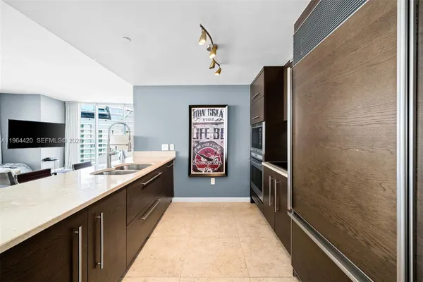 a hallway with painting on the wall and a sink