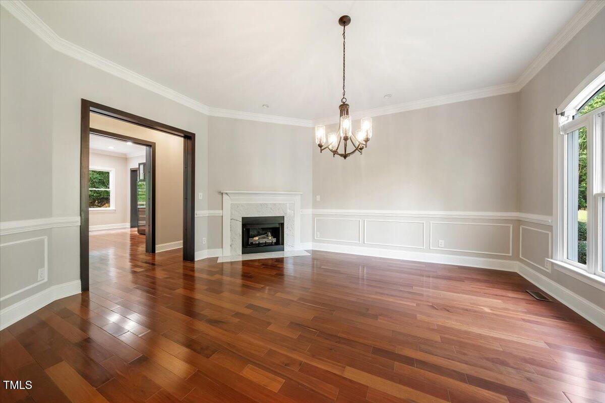 6300 Swallow Cove Lane Raleigh, NC 27614 - Photo 6 of 67 a view of a livingroom with wooden floor a fireplace and windows
