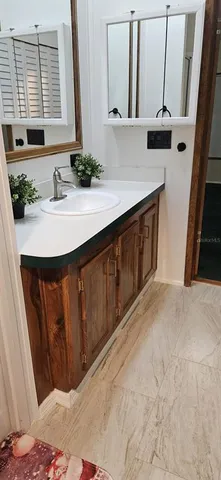 a bathroom with a sink a mirror and vanity