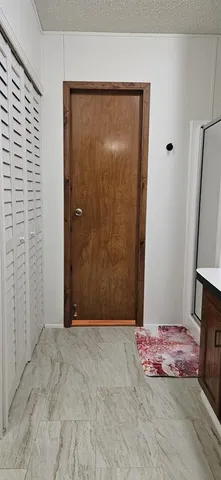 a view of a room with a wooden door