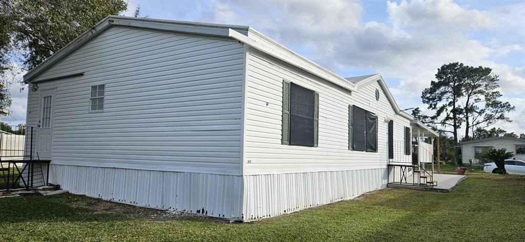 3636 South Lazy Lake Drive Lakeland, FL 33801 - Photo 27 of 28 a view of a white house with a large window and a yard